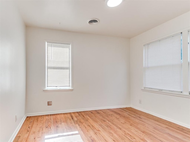 unfurnished room with light wood-type flooring