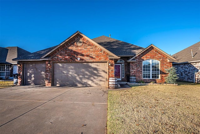 view of front of house with a garage and a front lawn