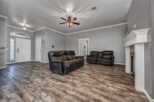 living room featuring ceiling fan, crown molding, and dark wood-type flooring