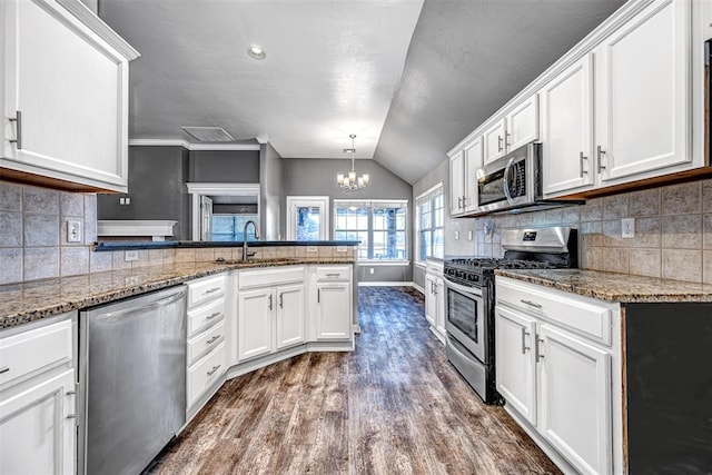 kitchen featuring stainless steel appliances, white cabinetry, dark wood-type flooring, and sink