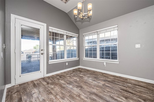 unfurnished dining area with dark wood-type flooring, lofted ceiling, and an inviting chandelier