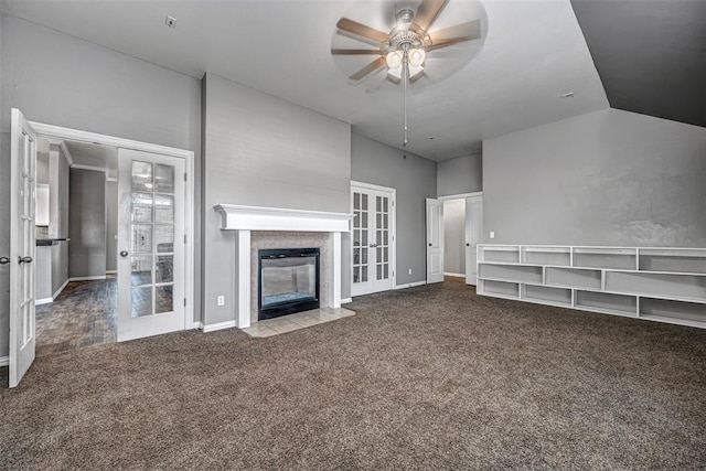 unfurnished living room with carpet flooring, french doors, vaulted ceiling, and ceiling fan