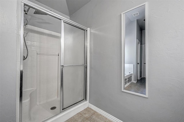 bathroom featuring tile patterned flooring and walk in shower