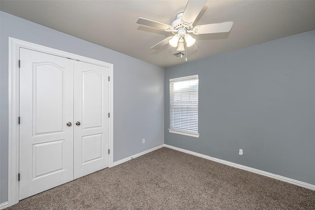 unfurnished bedroom with carpet, ceiling fan, and a closet