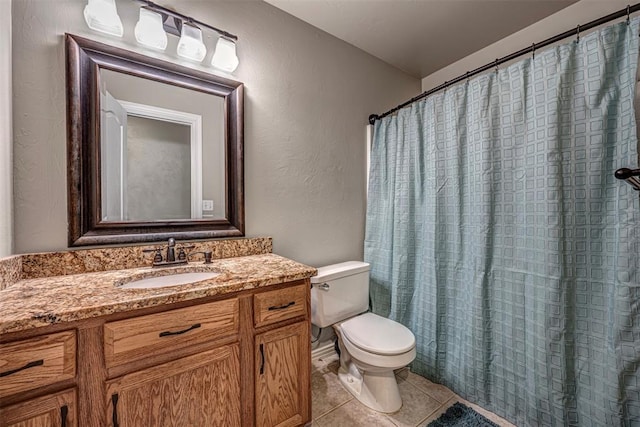 bathroom featuring tile patterned floors, vanity, and toilet