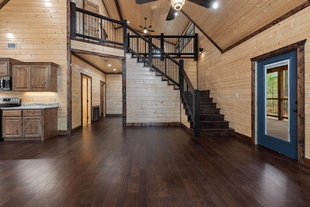 unfurnished living room with high vaulted ceiling, dark hardwood / wood-style floors, wood ceiling, and wooden walls