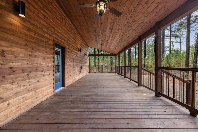 wooden terrace with ceiling fan and covered porch