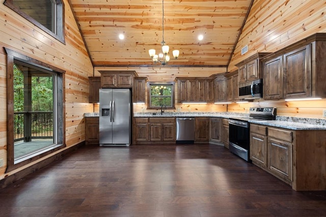 kitchen featuring plenty of natural light, light stone counters, and stainless steel appliances