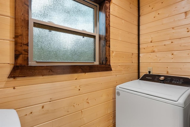 laundry area with washer / dryer and wooden walls