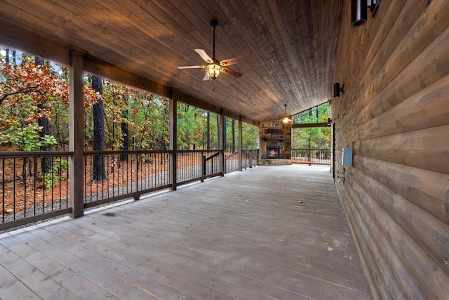 view of patio with ceiling fan and an outdoor stone fireplace