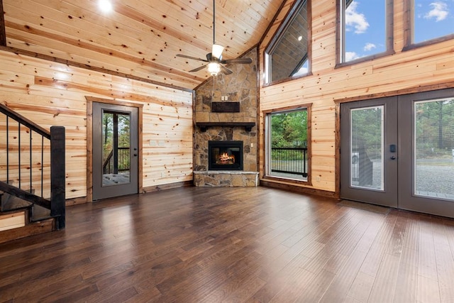 unfurnished living room with french doors, high vaulted ceiling, dark hardwood / wood-style floors, and plenty of natural light