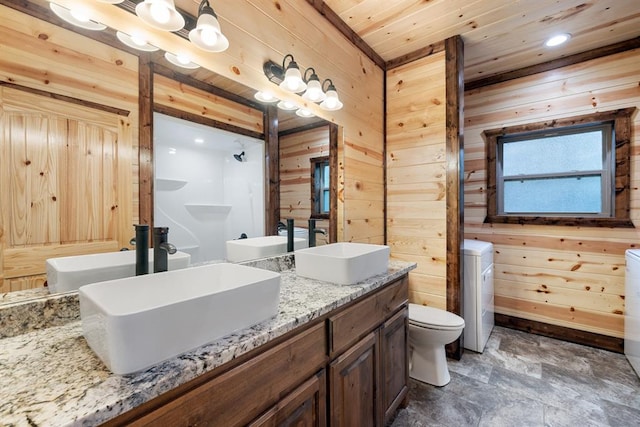 bathroom featuring a notable chandelier, wood walls, toilet, vanity, and wood ceiling