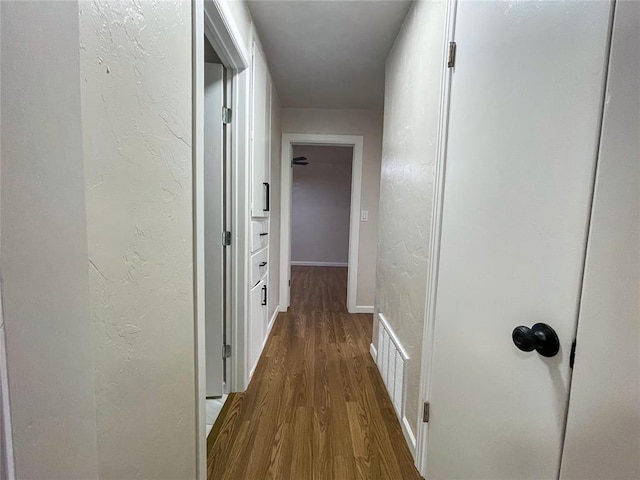 corridor featuring hardwood / wood-style floors