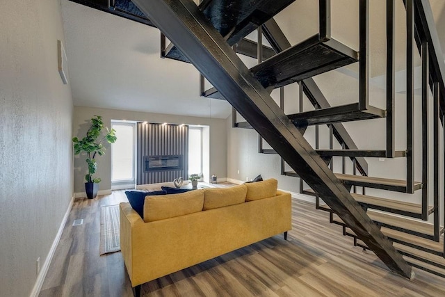 living room with high vaulted ceiling and hardwood / wood-style flooring