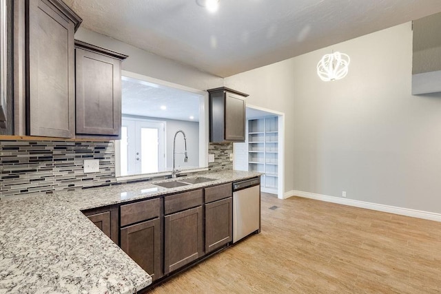 kitchen with dishwasher, decorative backsplash, light hardwood / wood-style floors, and sink