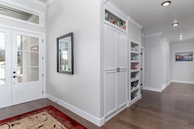 entrance foyer with crown molding, dark wood-type flooring, and french doors