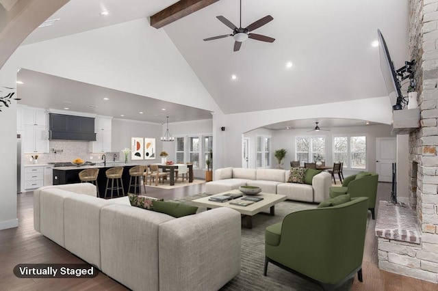 living room featuring beamed ceiling, dark hardwood / wood-style flooring, high vaulted ceiling, and ceiling fan with notable chandelier