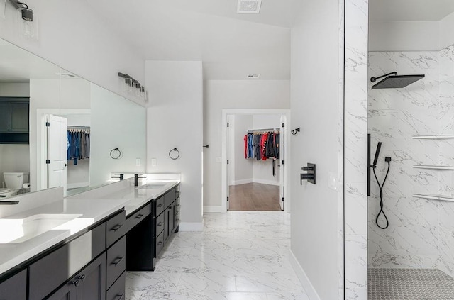 bathroom featuring toilet, hardwood / wood-style floors, vanity, and tiled shower