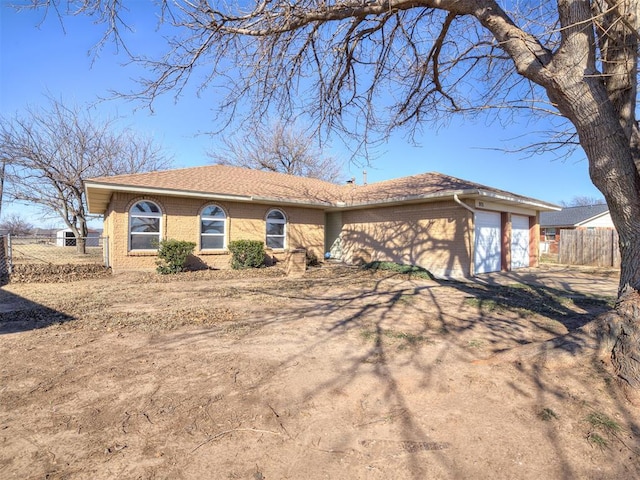 ranch-style home featuring a garage