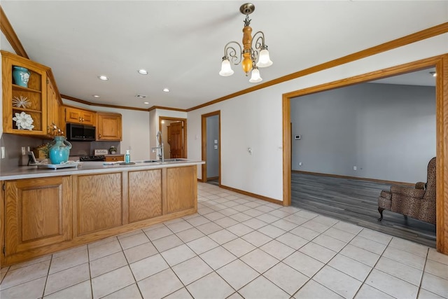 kitchen featuring kitchen peninsula, ornamental molding, light tile patterned floors, a notable chandelier, and hanging light fixtures