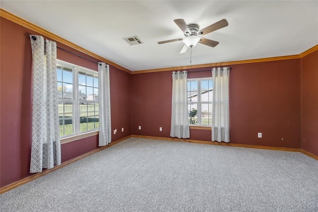 spare room with plenty of natural light, ceiling fan, carpet floors, and crown molding