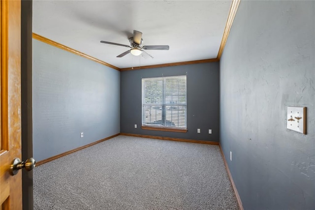 carpeted spare room featuring ceiling fan and ornamental molding