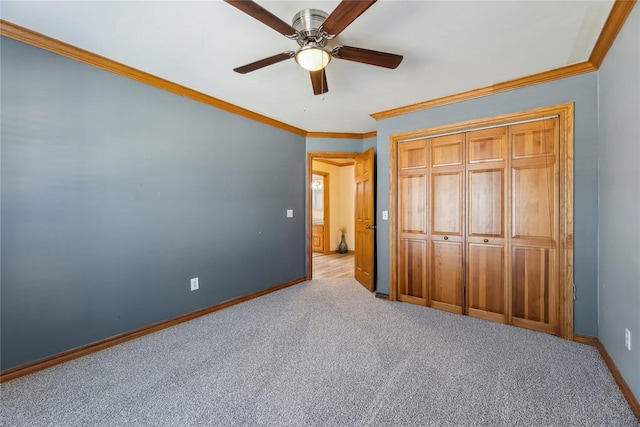 unfurnished bedroom with crown molding, a closet, ceiling fan, and light carpet