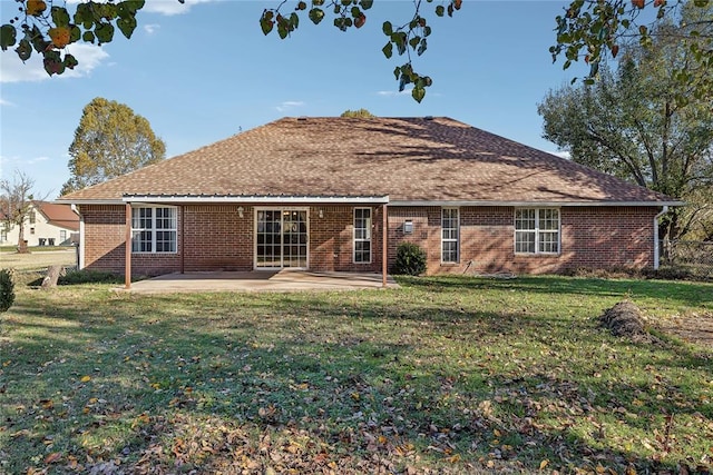 rear view of house with a patio area and a yard