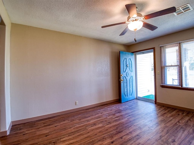 unfurnished room with hardwood / wood-style floors, a textured ceiling, and ceiling fan