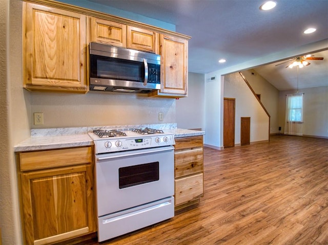 kitchen with ceiling fan, white range with gas stovetop, and wood-type flooring