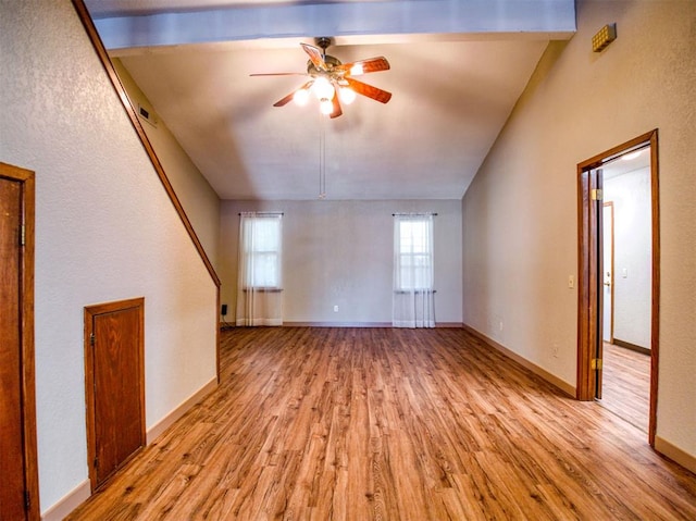 unfurnished living room with ceiling fan, light hardwood / wood-style floors, and vaulted ceiling