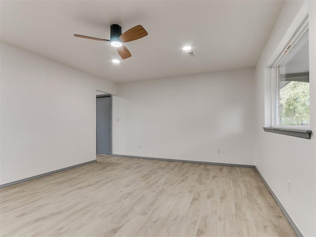 spare room featuring ceiling fan and light wood-type flooring