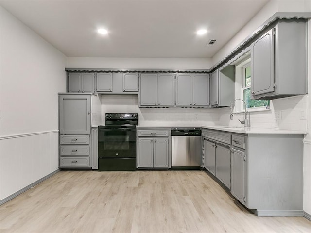 kitchen with stainless steel dishwasher, light hardwood / wood-style floors, sink, electric range, and gray cabinets