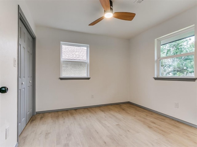 unfurnished room with ceiling fan and light wood-type flooring