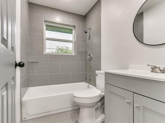 full bathroom featuring tile patterned flooring, vanity, toilet, and tiled shower / bath combo