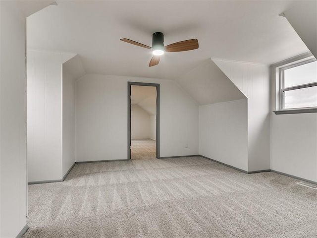 bonus room featuring ceiling fan, light colored carpet, and lofted ceiling