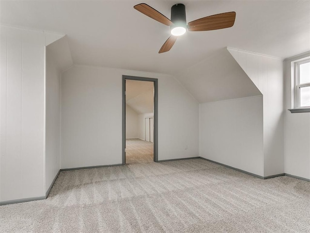 additional living space with light carpet, ceiling fan, and lofted ceiling