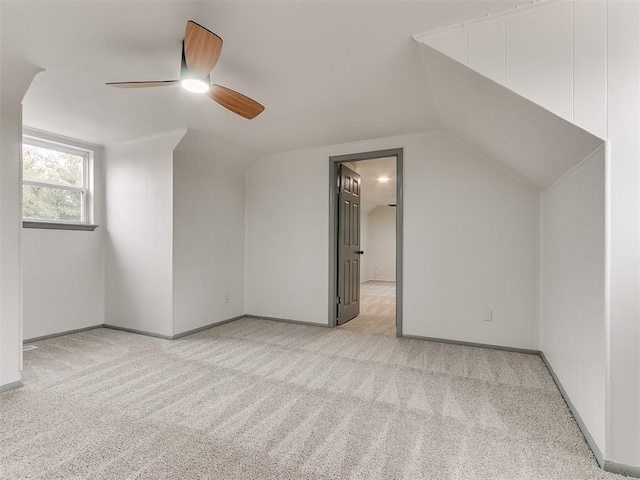 bonus room featuring light colored carpet, vaulted ceiling, and ceiling fan