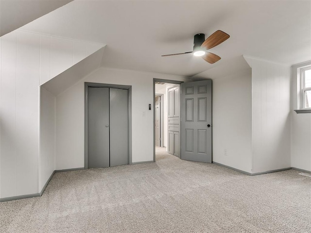 additional living space featuring ceiling fan, light colored carpet, and lofted ceiling