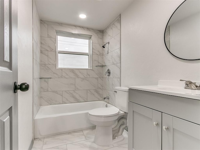 full bathroom with vanity, tiled shower / bath combo, and toilet