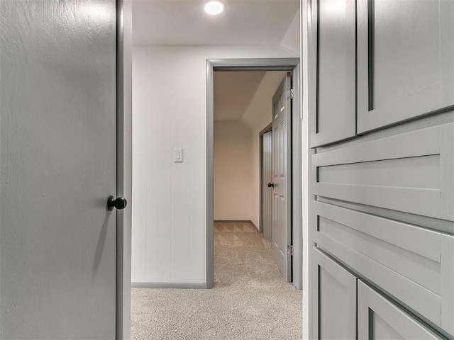 hallway featuring light colored carpet