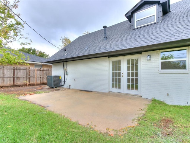 rear view of property with french doors, cooling unit, and a patio