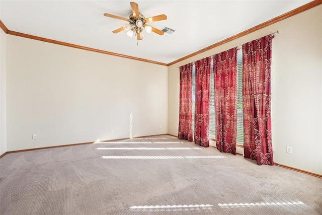 carpeted spare room featuring ceiling fan and ornamental molding