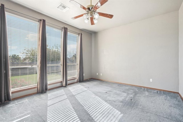 carpeted spare room with ceiling fan