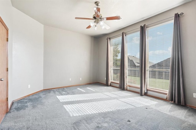 unfurnished room featuring light carpet and ceiling fan