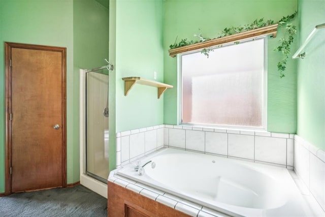 bathroom featuring shower with separate bathtub