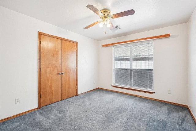 unfurnished bedroom with carpet, a closet, and ceiling fan