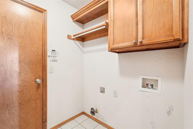 clothes washing area featuring cabinets, washer hookup, hookup for a gas dryer, and light tile patterned floors