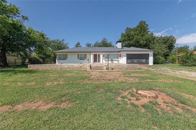 ranch-style house featuring a garage and a front lawn