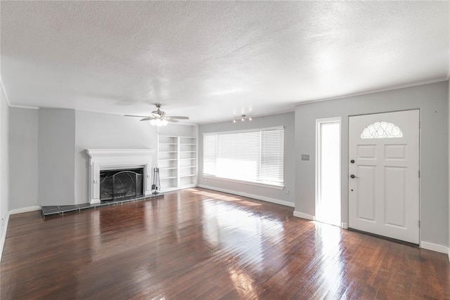 entrance foyer featuring dark hardwood / wood-style floors, ceiling fan, crown molding, and a textured ceiling